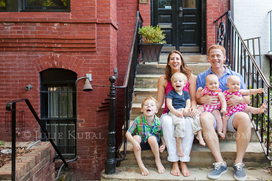 Family of 6 sitting on steps for photos before move to new home