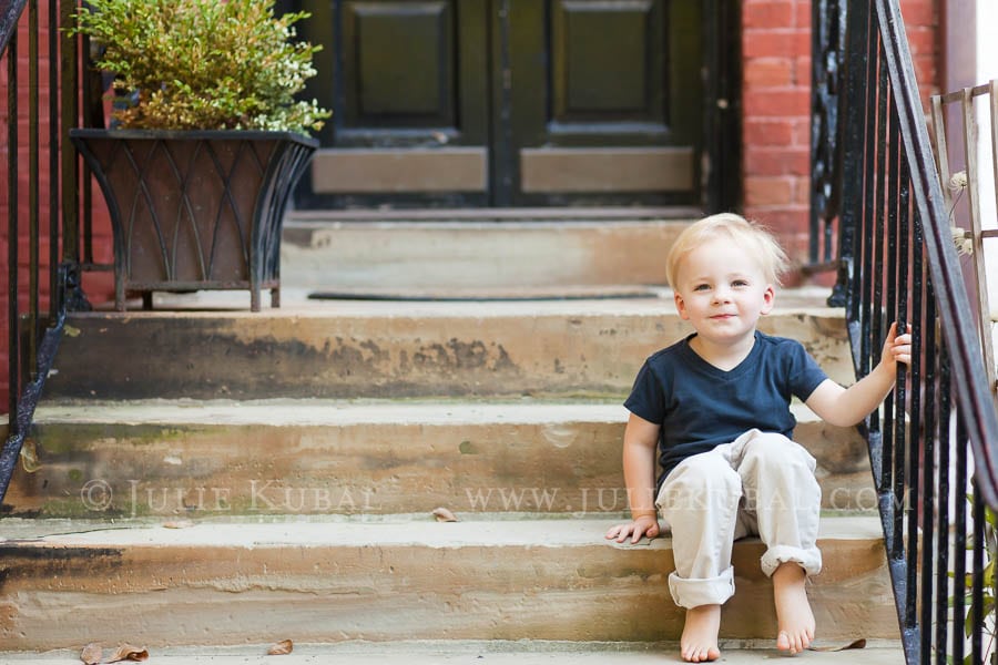 Young boy sits on front stoop of family row home in Dupont Circle photographed to document family before move to a new neighborhood.