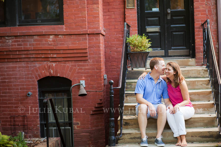 Husband and wife sit on the front stoop of their Dupont Circle row house photographed before family move