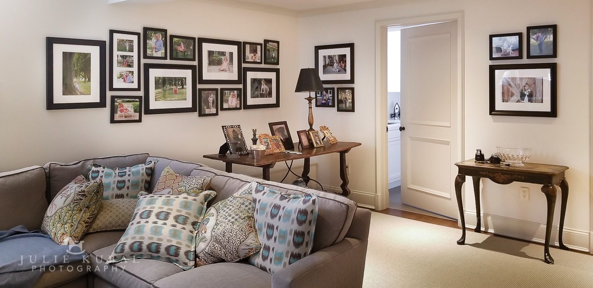 A creative way to display family photos is to build a photo wall gallery like this one. It was designed for client's home featuring images by Julie Kubal Photography from 4 years of family photo sessions.