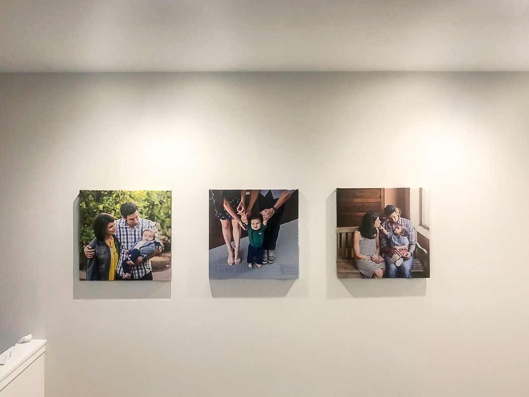 3 large fine-art canvas gallery wraps of family photos displayed in upper hallway of client's home.