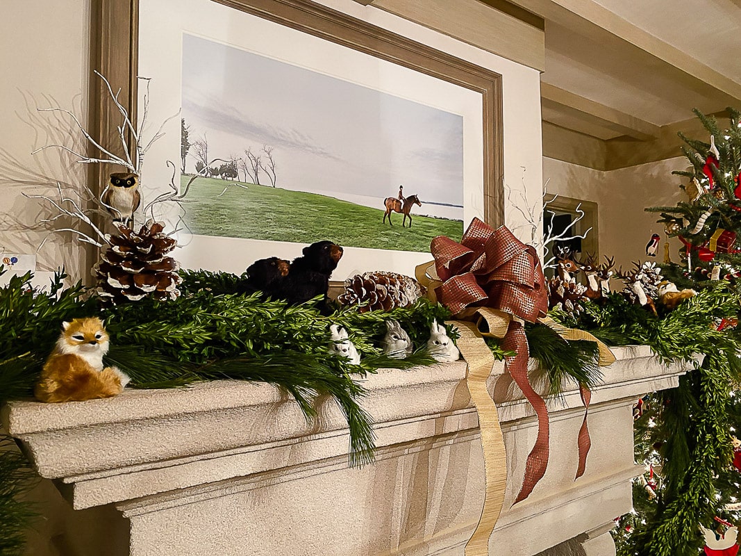 large framed photo of girl on horseback riding in an open field, displayed above fireplace mantle from family photo session in Washington, DC by Julie Kubal