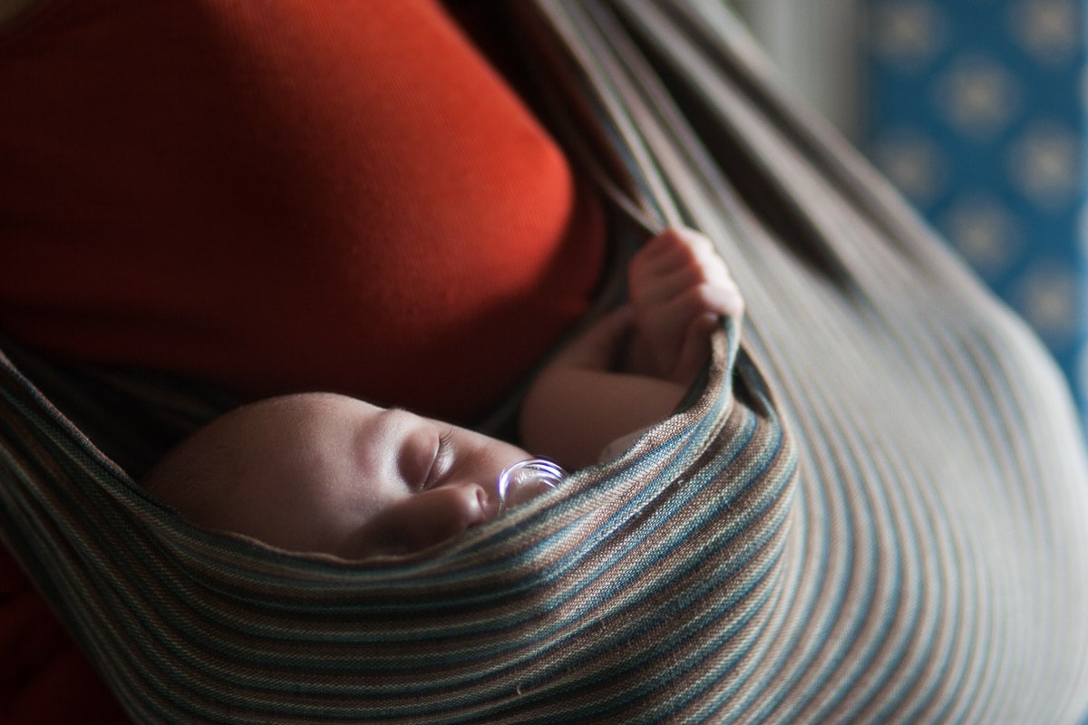 self-portrait of Washington DC photographer Julie Kubal taken carrying newborn in a sling.