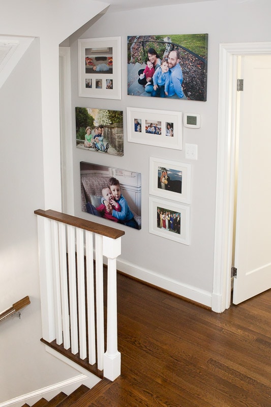 Gallery wall of photos displayed prominently in family home