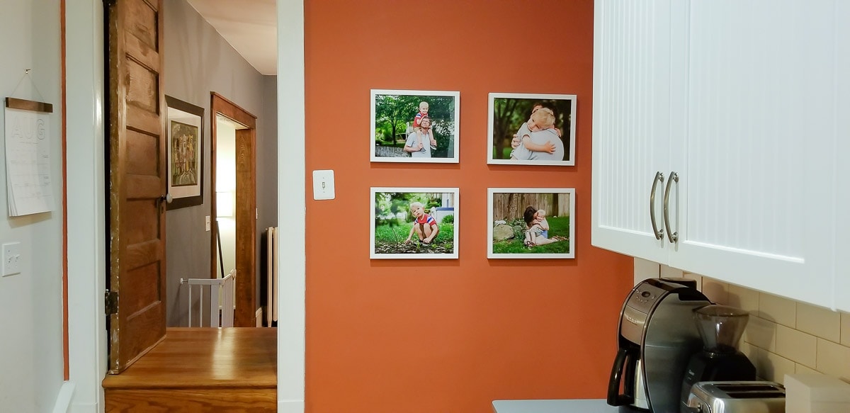 framed prints of family photos displayed on a wall in the kitchen of this Washington, DC home